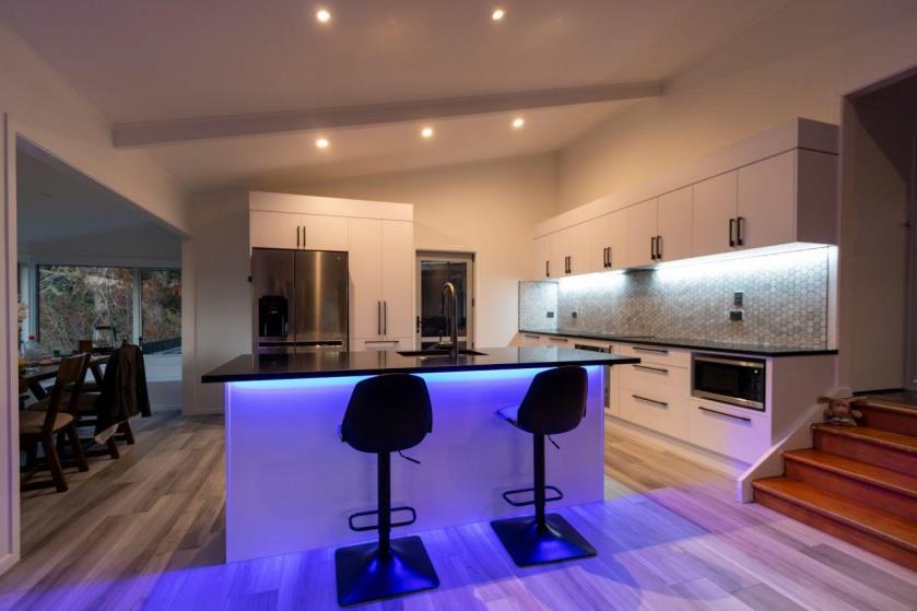 Modern white kitchen with LED strip lighting