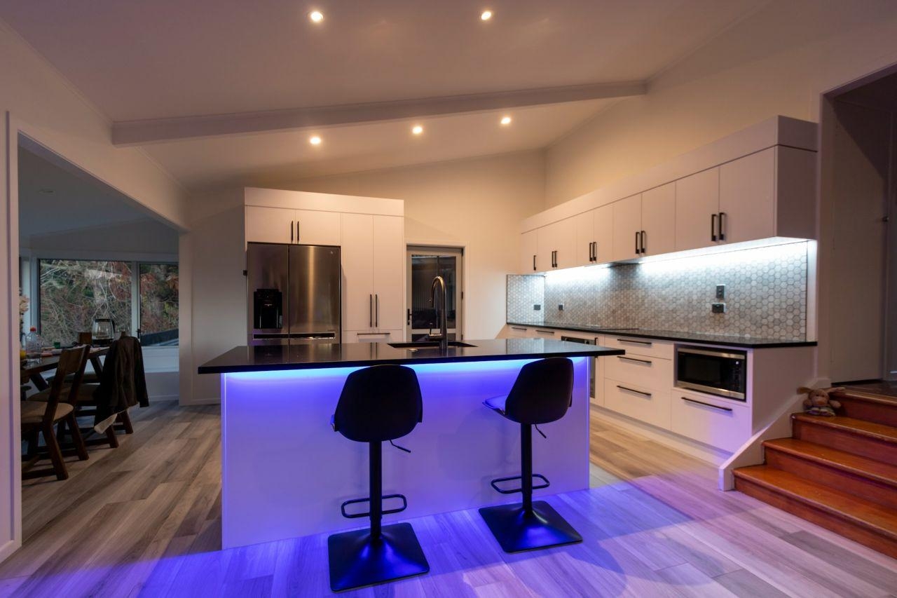 Modern white kitchen with LED strip lighting