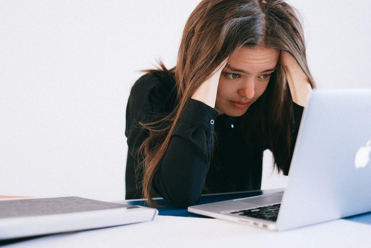 Stressed woman looking at her laptop